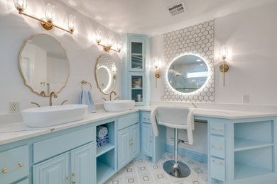 Inspiration for a large transitional master ceramic tile and white tile porcelain tile, multicolored floor and double-sink walk-in shower remodel in Oklahoma City with raised-panel cabinets, blue cabinets, white walls, a vessel sink, granite countertops, a hinged shower door, white countertops, a niche and a built-in vanity