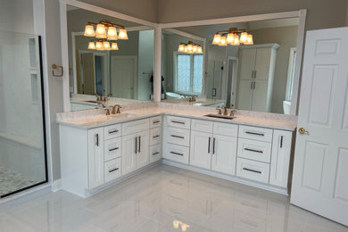 Bathroom - large transitional master double-sink bathroom idea in Chicago with recessed-panel cabinets, white cabinets, quartz countertops, white countertops and a built-in vanity