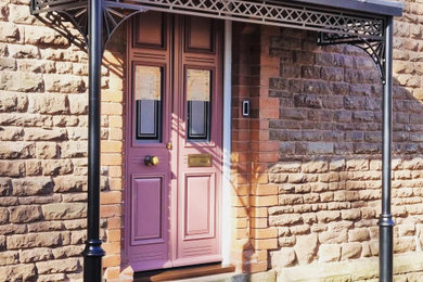 This is an example of a large traditional porch in West Midlands with a double front door.