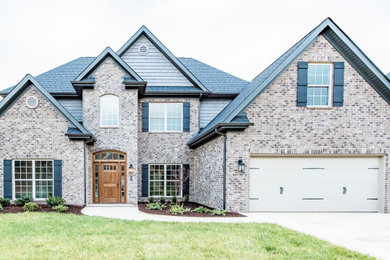 Brown exterior home photo in Other with a shingle roof