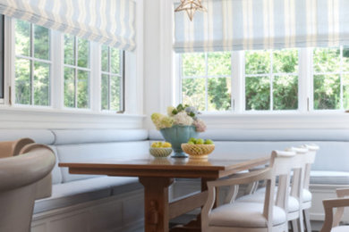 Inspiration for a large transitional u-shaped dark wood floor and brown floor kitchen remodel in St Louis with a farmhouse sink, recessed-panel cabinets, white cabinets, marble countertops, white backsplash, an island and white countertops
