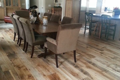 Example of a mid-sized classic medium tone wood floor and brown floor dining room design in San Diego with beige walls and no fireplace