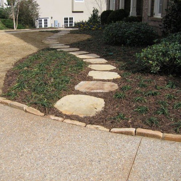Fieldstone stepping stones meets Pea Gravel driveway and fieldstone edging