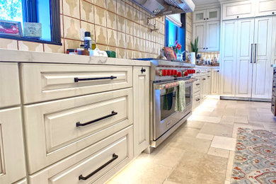 Photo of a large traditional eat-in kitchen in Los Angeles with white cabinets, marble benchtops, ceramic splashback, stainless steel appliances, ceramic floors, with island, white floor and white benchtop.