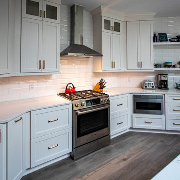 3 Finishes on Kitchen Cabinetry with Galley Workstation in Island and Wine Bar