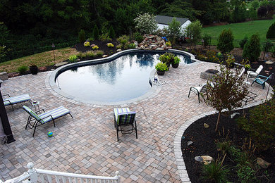Pool - backyard brick and kidney-shaped pool idea in DC Metro
