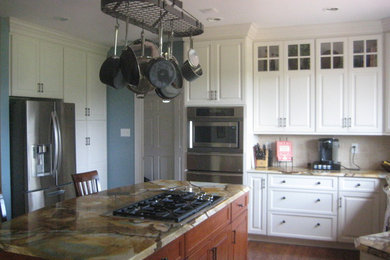 Open concept kitchen - mid-sized transitional l-shaped dark wood floor open concept kitchen idea in Philadelphia with shaker cabinets, white cabinets, beige backsplash, cement tile backsplash, stainless steel appliances, an island and a double-bowl sink