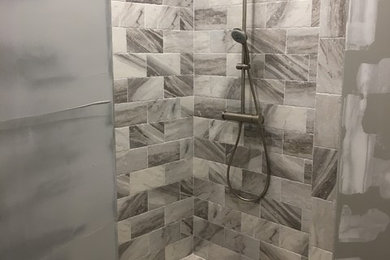 Inspiration for a contemporary beige tile bathroom remodel in Baltimore
