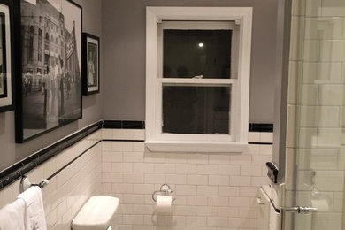 This is an example of a small bohemian shower room bathroom in Salt Lake City with a pedestal sink, shaker cabinets, white cabinets, tiled worktops, an alcove shower, a one-piece toilet, black and white tiles, metro tiles, grey walls and mosaic tile flooring.