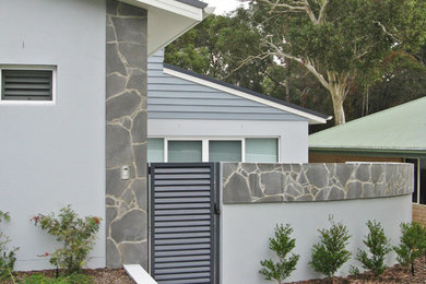 Photo of a mid-sized contemporary two-storey blue exterior in Sydney.