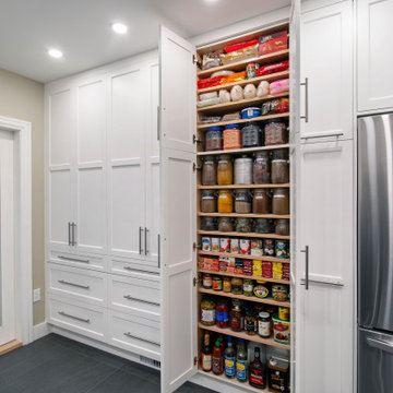 Functional & Stylish White Kitchen with Dark Countertops and Backsplash