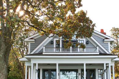Example of a beach style gray two-story gable roof design in New York