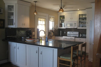 Small farmhouse galley light wood floor eat-in kitchen photo in New York with an undermount sink, recessed-panel cabinets, white cabinets, quartz countertops, beige backsplash, porcelain backsplash, white appliances and an island