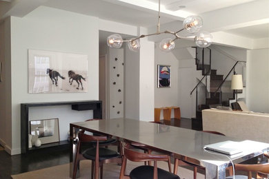Photo of a mid-sized eclectic open plan dining in New York with white walls, dark hardwood floors and no fireplace.
