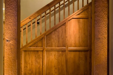 Photo of a mid-sized arts and crafts wood straight staircase in Albuquerque with wood risers, wood railing and wood walls.