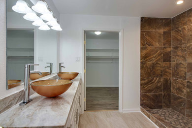 Inspiration for a mid-sized rustic master brown tile and porcelain tile limestone floor, beige floor and double-sink bathroom remodel in Austin with shaker cabinets, white cabinets, a two-piece toilet, white walls, a vessel sink, quartzite countertops, gray countertops and a built-in vanity