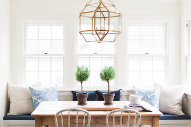 Example of a mid-sized transitional kitchen/dining room combo design in Chicago with white walls and no fireplace