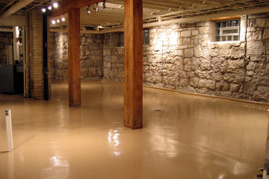 Basement - mid-sized rustic look-out concrete floor and brown floor basement idea with multicolored walls