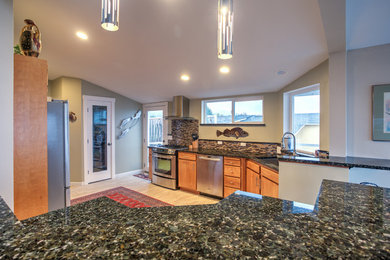 Large mountain style u-shaped light wood floor and brown floor open concept kitchen photo in Seattle with an undermount sink, flat-panel cabinets, medium tone wood cabinets, granite countertops, multicolored backsplash, matchstick tile backsplash, stainless steel appliances and an island