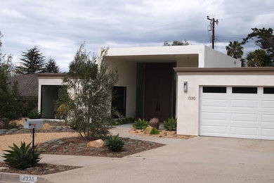 Large 1960s beige one-story stucco flat roof photo in Santa Barbara
