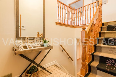 Large mountain style ceramic tile and beige floor entryway photo in Other with beige walls
