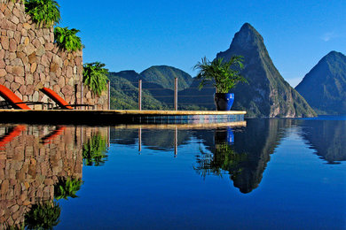 Inspiration for a large contemporary custom-shaped infinity pool remodel with decking