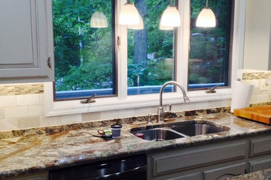 Inspiration for a mid-sized timeless l-shaped medium tone wood floor eat-in kitchen remodel in Other with a double-bowl sink, raised-panel cabinets, white cabinets, granite countertops, beige backsplash, stone tile backsplash, stainless steel appliances and an island