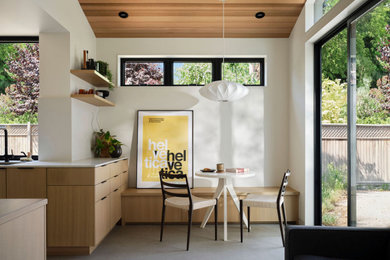 Small trendy concrete floor, gray floor and wood ceiling breakfast nook photo in Sacramento with white walls