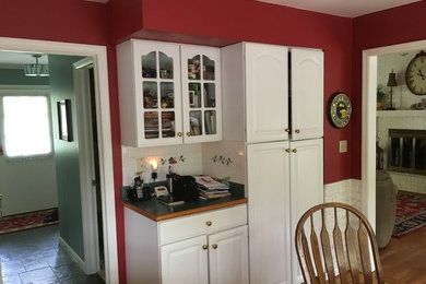 Mid-sized elegant l-shaped terra-cotta tile and brown floor eat-in kitchen photo in Other with open cabinets, white cabinets, laminate countertops, white backsplash, ceramic backsplash, an island, green countertops, a double-bowl sink and white appliances