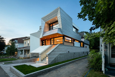 This is an example of a mid-sized contemporary two-storey white house exterior in Ottawa with mixed siding and a flat roof.