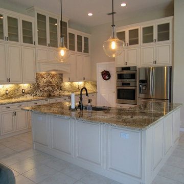 Full height back splash ivory kitchen.