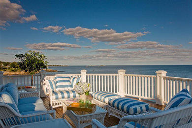 Inspiration for a large timeless back porch remodel in Boston