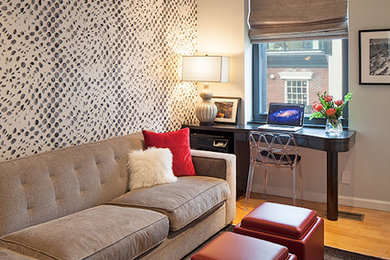 Living room - mid-sized contemporary enclosed medium tone wood floor living room idea in New York with gray walls, a wall-mounted tv and no fireplace