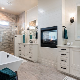 Inspiration for a mid-sized transitional master ceramic tile and gray tile laminate floor and multicolored floor bathroom remodel in Boise with recessed-panel cabinets, white cabinets, white walls, a hinged shower door, an undermount sink, laminate countertops, a two-piece toilet and white countertops