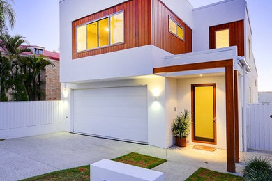 This is an example of a mid-sized contemporary two-storey white exterior in Brisbane with mixed siding and a flat roof.
