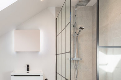 Photo of a small modern shower room bathroom in Surrey with white cabinets, a walk-in shower, a two-piece toilet, grey tiles, grey walls, ceramic flooring, a vessel sink, grey floors, an open shower and a single sink.