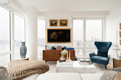 Example of a mid-sized trendy laminate floor and beige floor living room design in New York with white walls and no fireplace