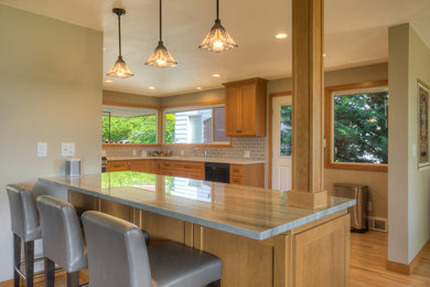 Inspiration for a mid-sized craftsman light wood floor eat-in kitchen remodel in Seattle with shaker cabinets, medium tone wood cabinets, quartzite countertops, gray backsplash, ceramic backsplash, stainless steel appliances and an island