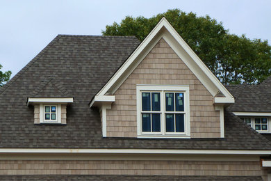 This is an example of a mid-sized arts and crafts two-storey brown exterior in Charlotte with wood siding.