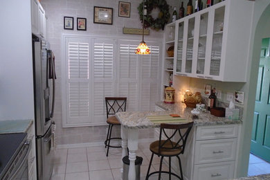 White painted kitchen cabinets with bevel edge laminate countertops