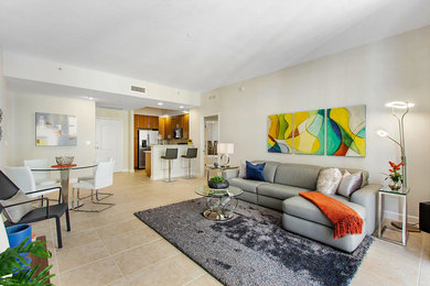 Mid-sized contemporary open concept family room in Miami with grey walls, slate floors and a wall-mounted tv.
