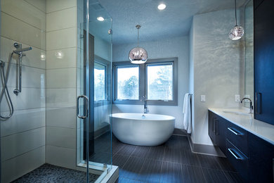 Inspiration for a large modern master gray tile and ceramic tile slate floor and gray floor bathroom remodel in Other with flat-panel cabinets, black cabinets, white walls, an undermount sink and a hinged shower door