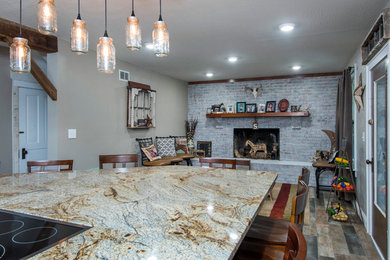 Open concept kitchen - mid-sized rustic single-wall ceramic tile and multicolored floor open concept kitchen idea in Columbus with an undermount sink, flat-panel cabinets, medium tone wood cabinets, granite countertops, brown backsplash, glass tile backsplash, stainless steel appliances and an island