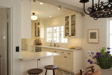 Small tuscan galley ceramic tile enclosed kitchen photo in San Francisco with an undermount sink, shaker cabinets, white cabinets, quartz countertops, white backsplash, subway tile backsplash, stainless steel appliances and no island