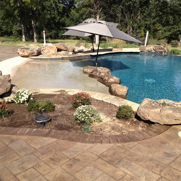 Beach entry, planter, accent boulders, two tone pool interior, swim up bar