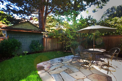 This is an example of a small traditional backyard partial sun garden in Portland.