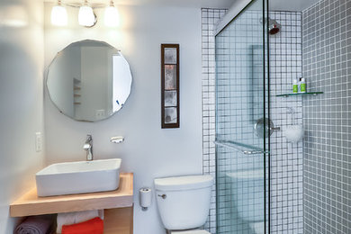 This is an example of a contemporary bathroom in DC Metro with wood benchtops, an alcove shower, a two-piece toilet, white tile and ceramic tile.