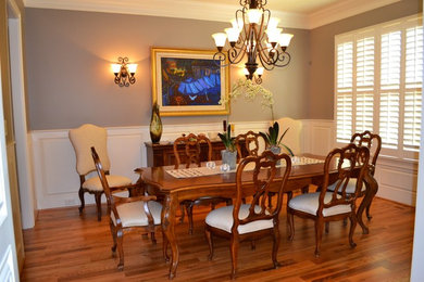 Inspiration for a mid-sized transitional dark wood floor enclosed dining room remodel in Raleigh with gray walls and no fireplace