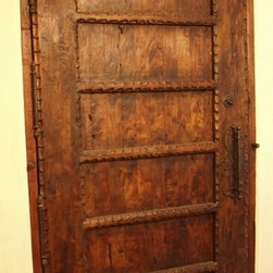 Spanish Mediterranean style front Door with hand carved details. The iron door p - Front Doors