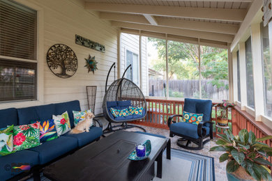Large trendy tile screened-in and wood railing back porch idea in Austin with a roof extension